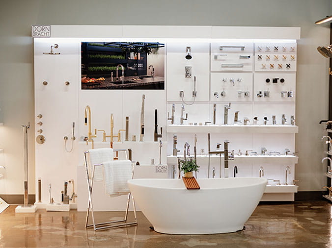 Bathtub and faucets on display in the FACETS of Chicago Kitchen & Bath Showroom